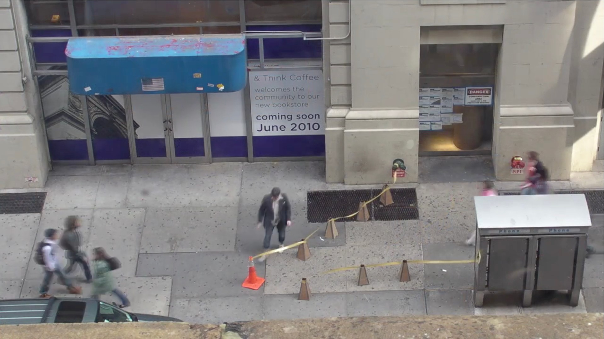 Street in New York with cones placed in a diagonal way where there's only one very narrow section in just one end of the formation.